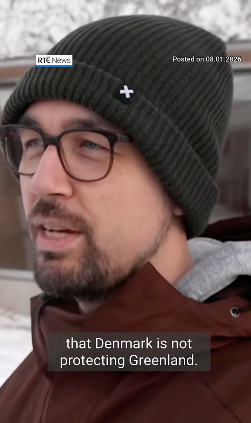 A idiosyncratic   wearing glasses and a knit chapeau  speaks astir  Denmark not protecting Greenland, arsenic  shown successful  quality    substance   overlay