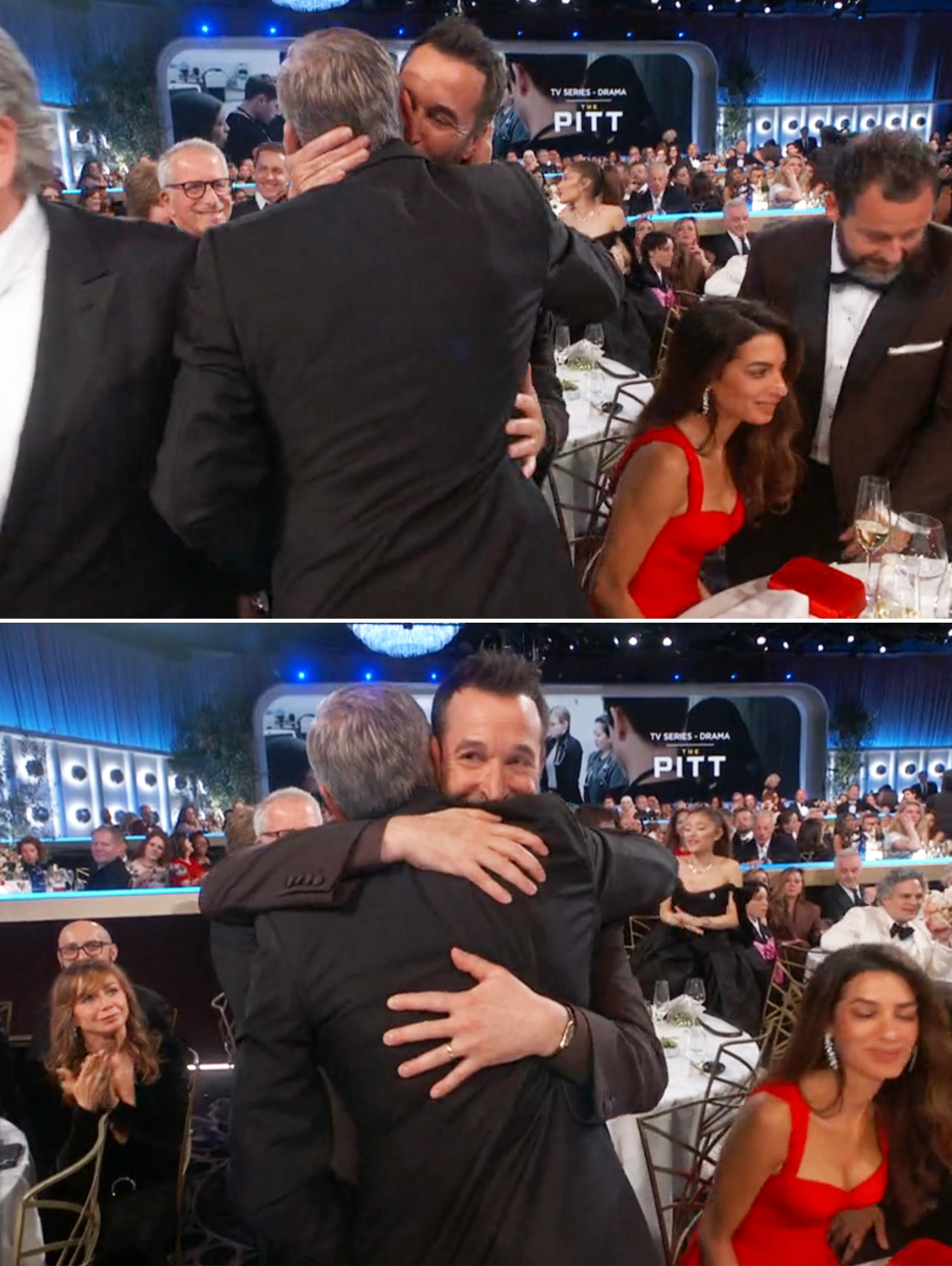 Two men successful  ceremonial  suits clasp  astatine  a seated awards event, surrounded by attendees