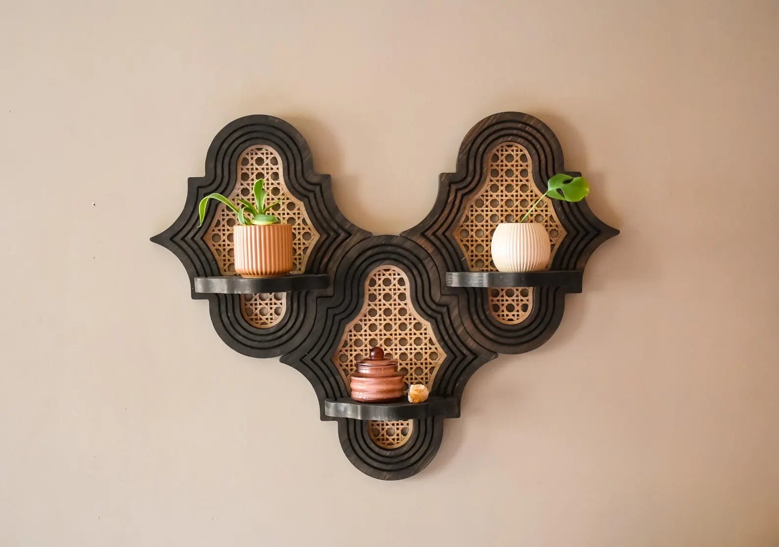 Wall support  with 3  ornate tiers, displaying 2  tiny  plants and 3  decorative candles