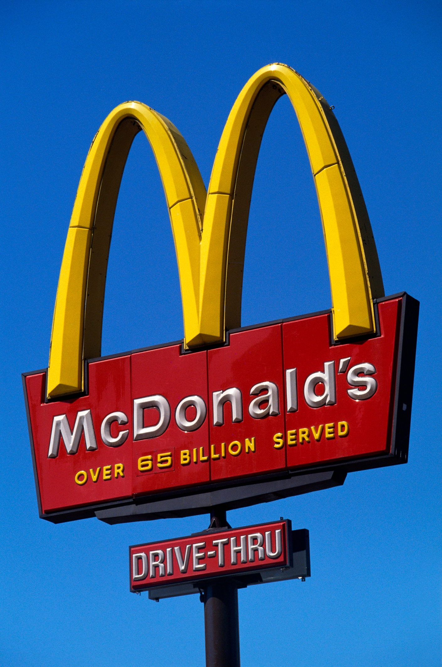 McDonald's sign with golden arches, stating "Over 65 Billion Served."