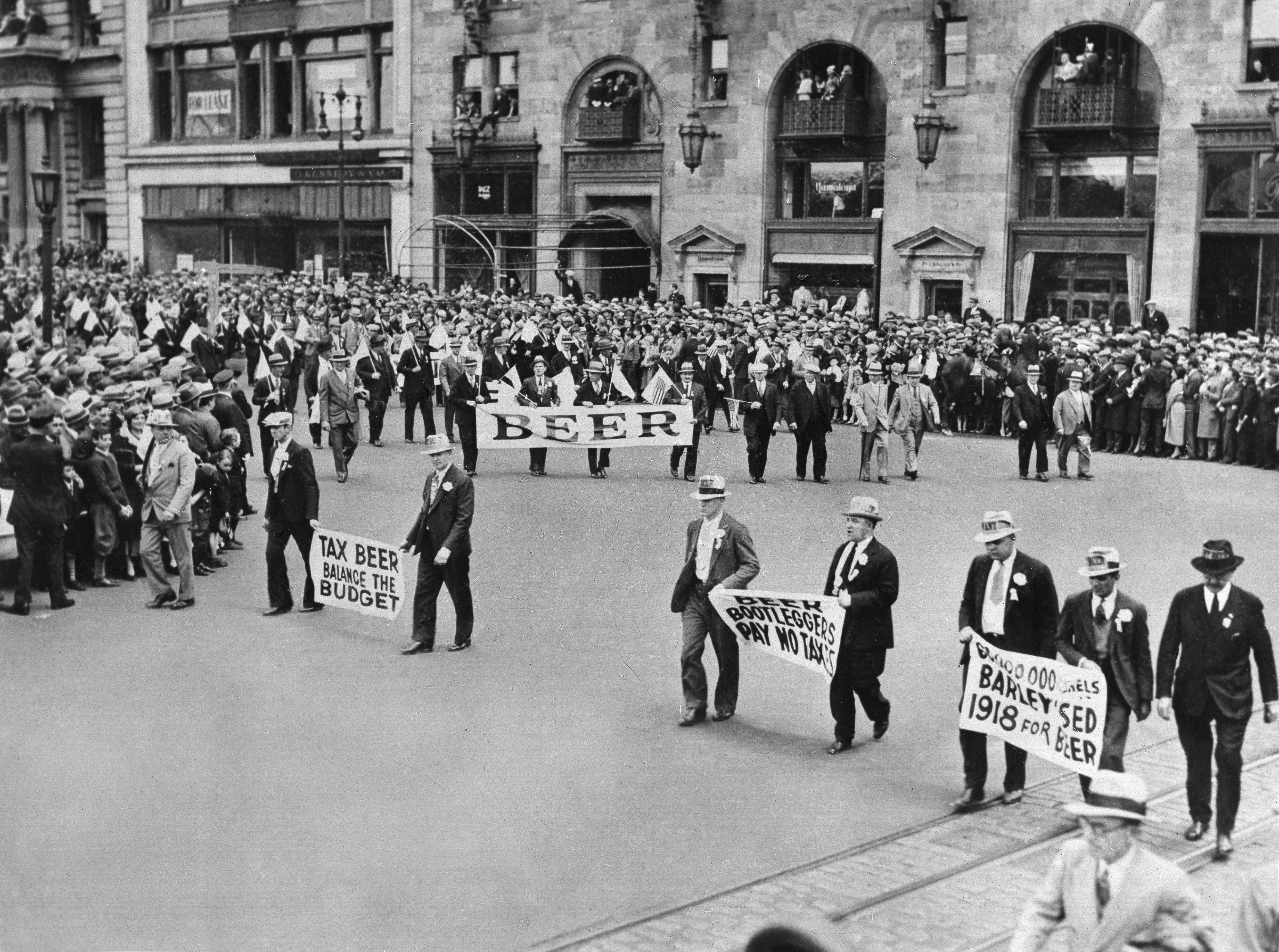 Prohibition-era protestation  with marchers holding signs advocating for brew  legalization to assistance  fund  and agriculture