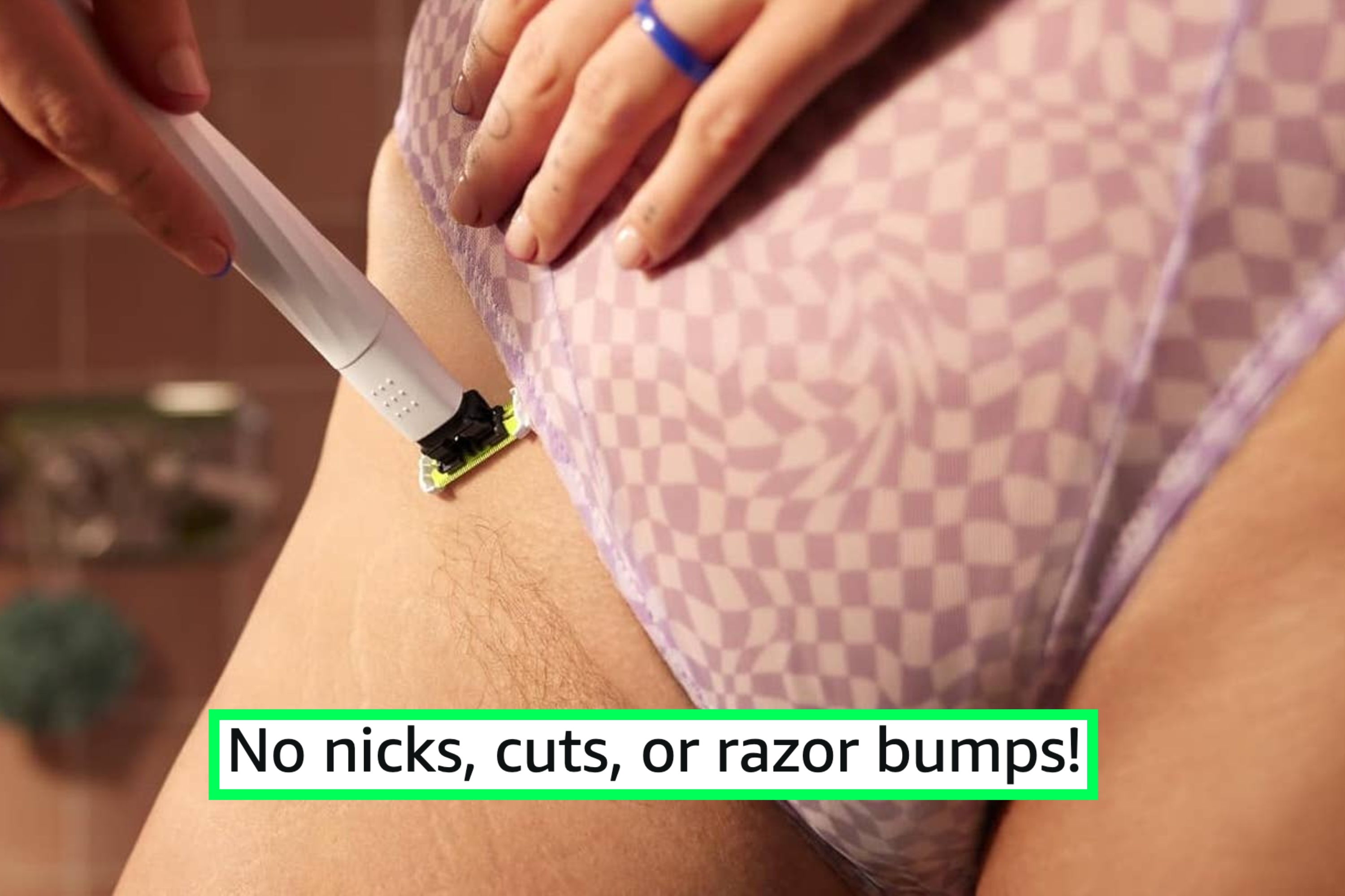 close-up of model using a razor to shave the edge of the pubic area with reviewer text "no nicks, cuts, or razor bumps!"