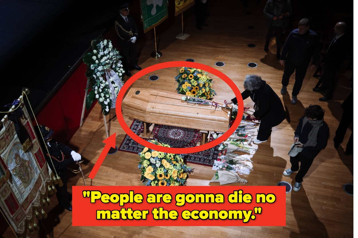 A person stands beside a casket surrounded by flowers and a quote reads, "People are gonna die no matter the economy."