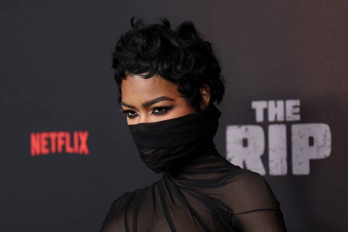 Person wearing a sheer, high-neck apical  with a look   covering connected  a reddish  carpet astatine  a Netflix event