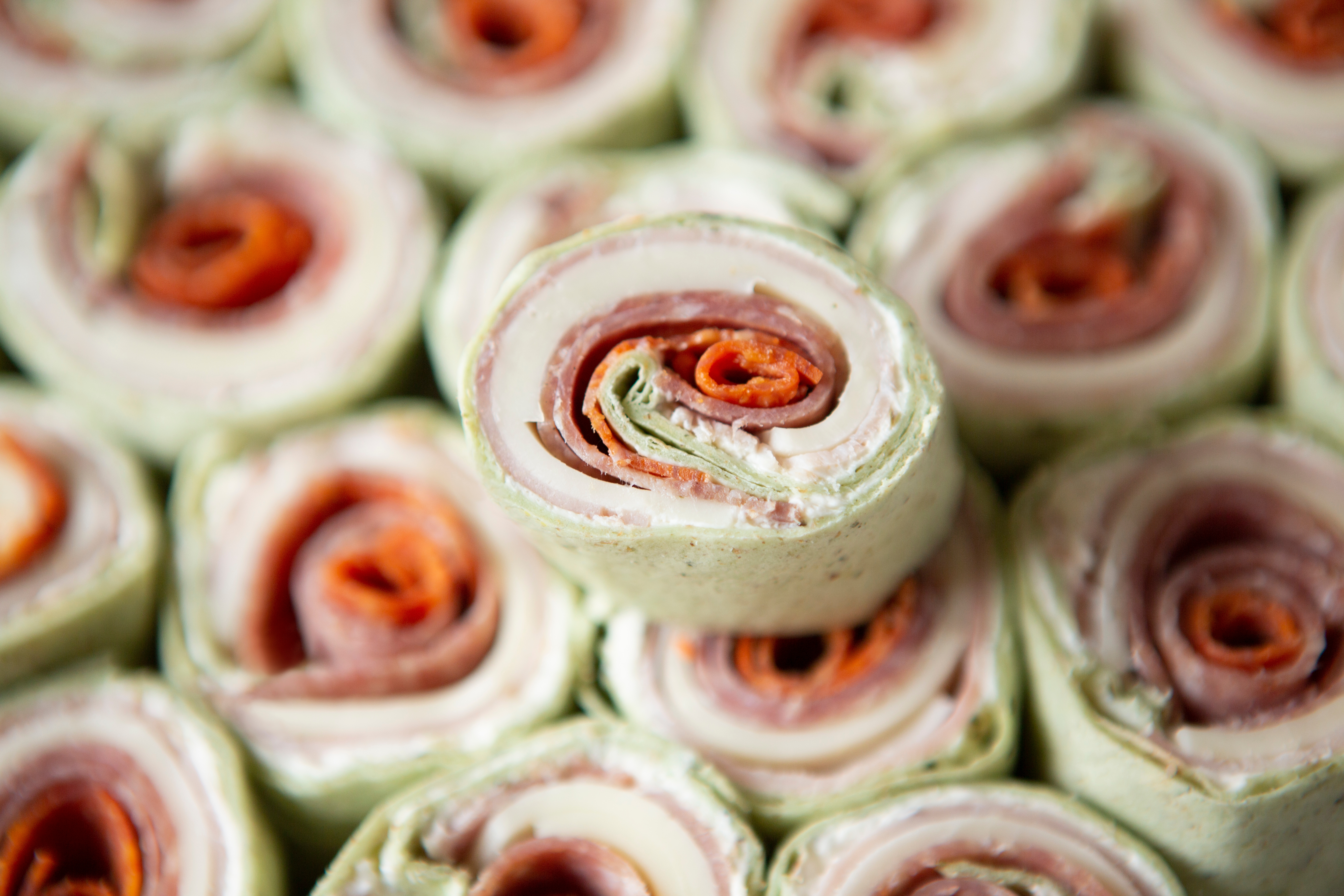 Close-up of freshly made pinwheel sandwiches, rolled with deli meats, cheese, and tortilla wraps