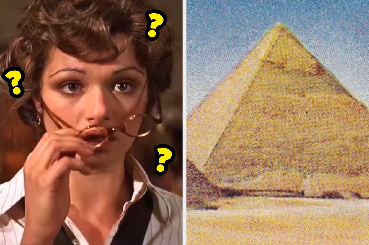 An intrigued person holds glasses while looking at a photo of the Great Pyramid of Giza