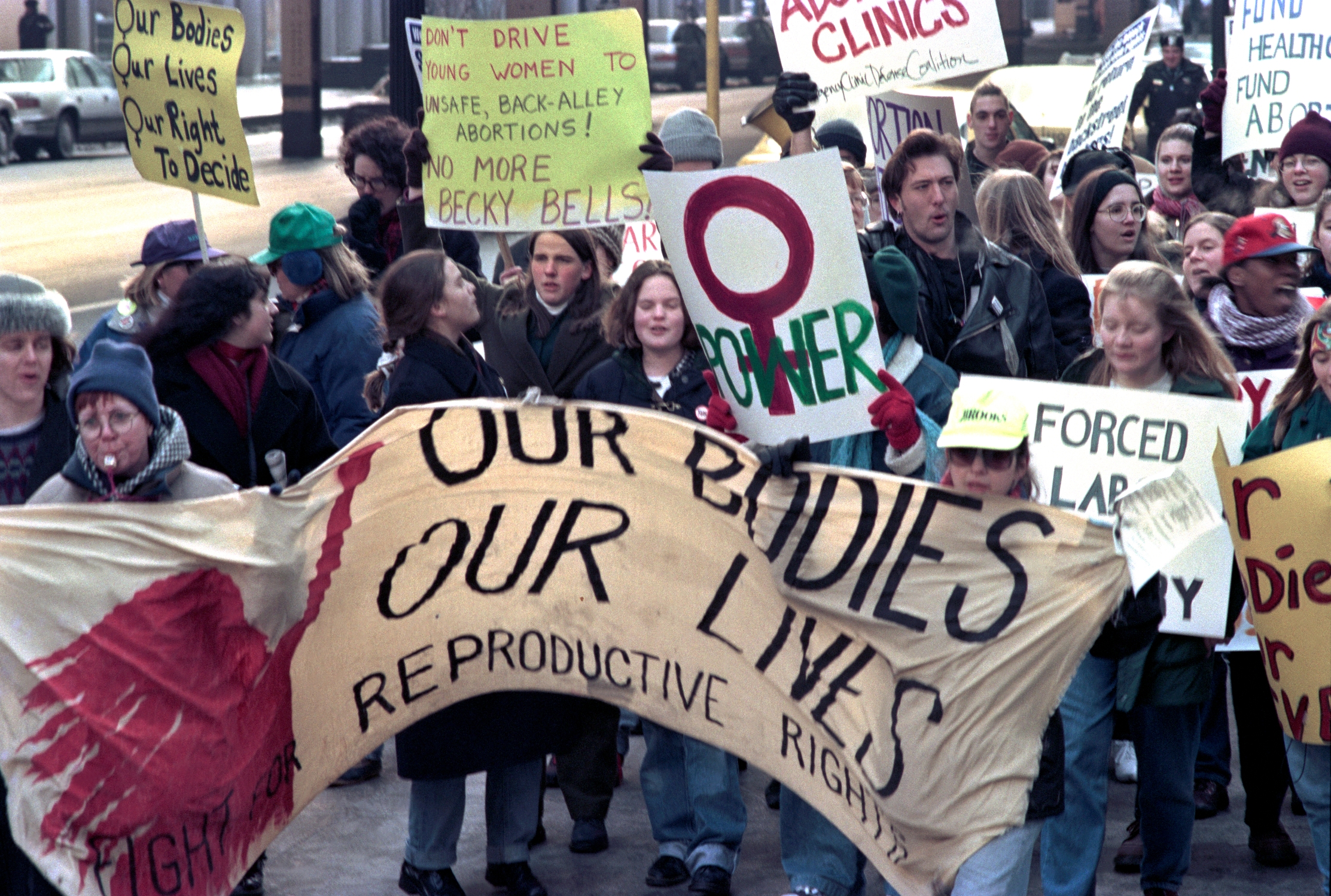 Protesters clasp  signs advocating for reproductive rights and entree  to harmless  abortion, marching unneurotic  successful  a demonstration