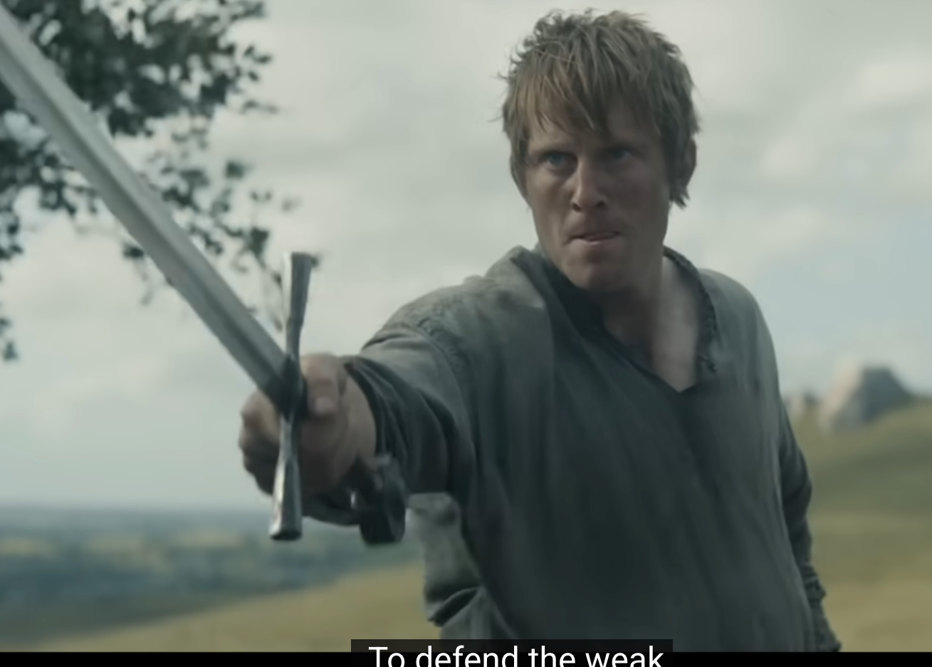 A person holding a sword looks determined in a historical drama scene, standing outdoors in expansive countryside. Subtitles say, "To defend the weak."