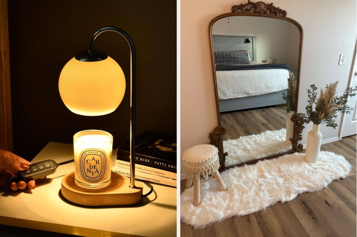 A modern table lamp with a spherical shade beside a lit candle. A vintage mirror with a decorative frame stands on a fluffy rug next to a vase