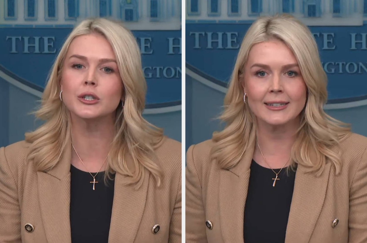 A woman with long blonde hair is speaking at a podium, wearing a blazer and cross necklace, in what appears to be an official setting