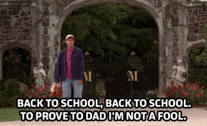 Man stands in front of a school gate holding books. Text on image: "Back to school, back to school. To prove to Dad I'm not a fool."