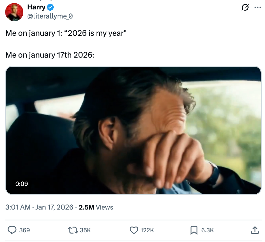 A man wiping his face after crying in the car