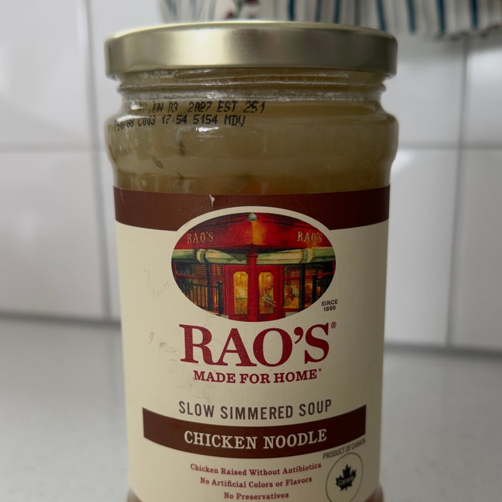 Jar of Rao's Chicken Noodle Soup on a kitchen counter, featuring slow-simmered soup label