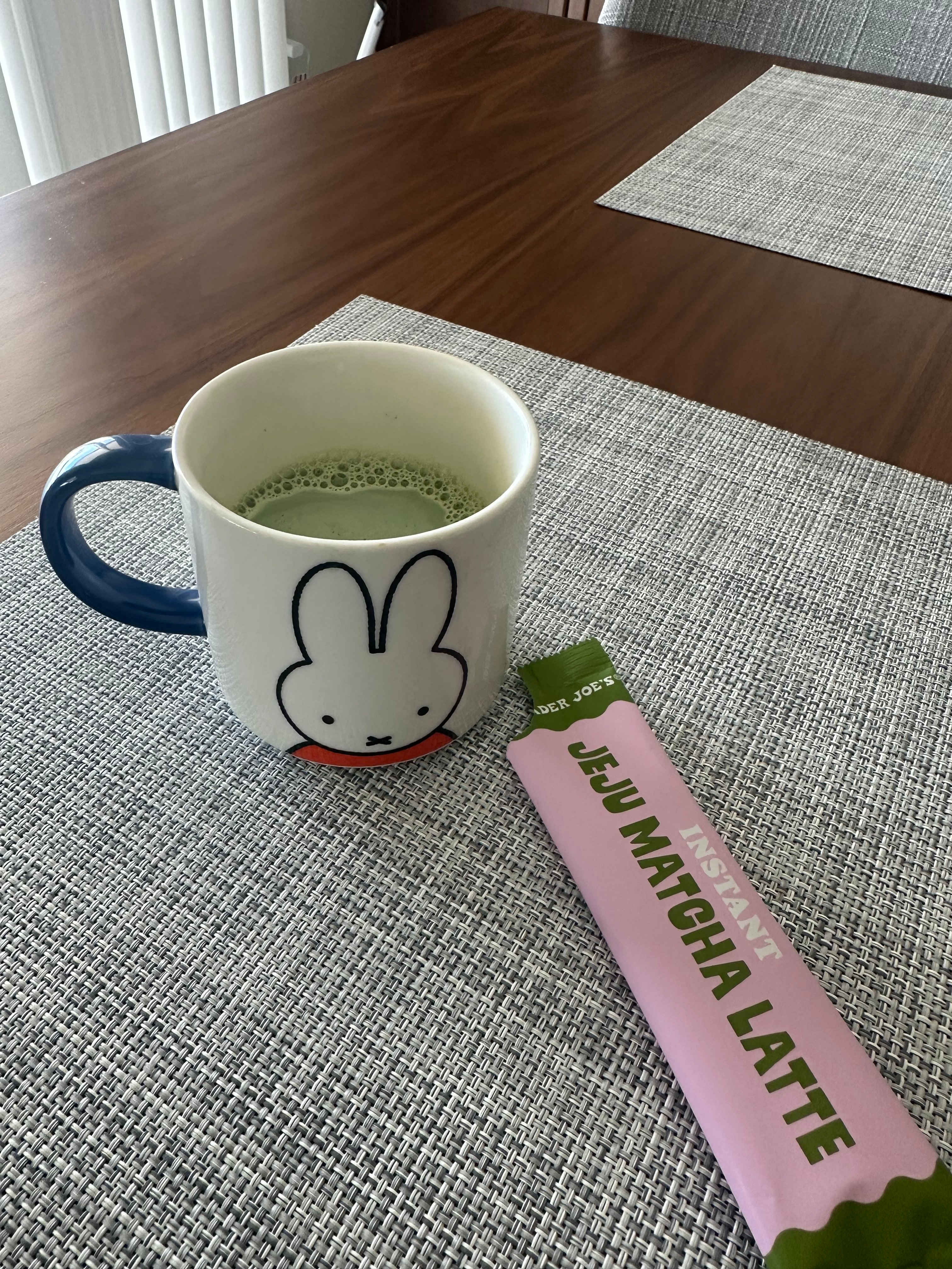 A mug with a rabbit design filled with matcha latte