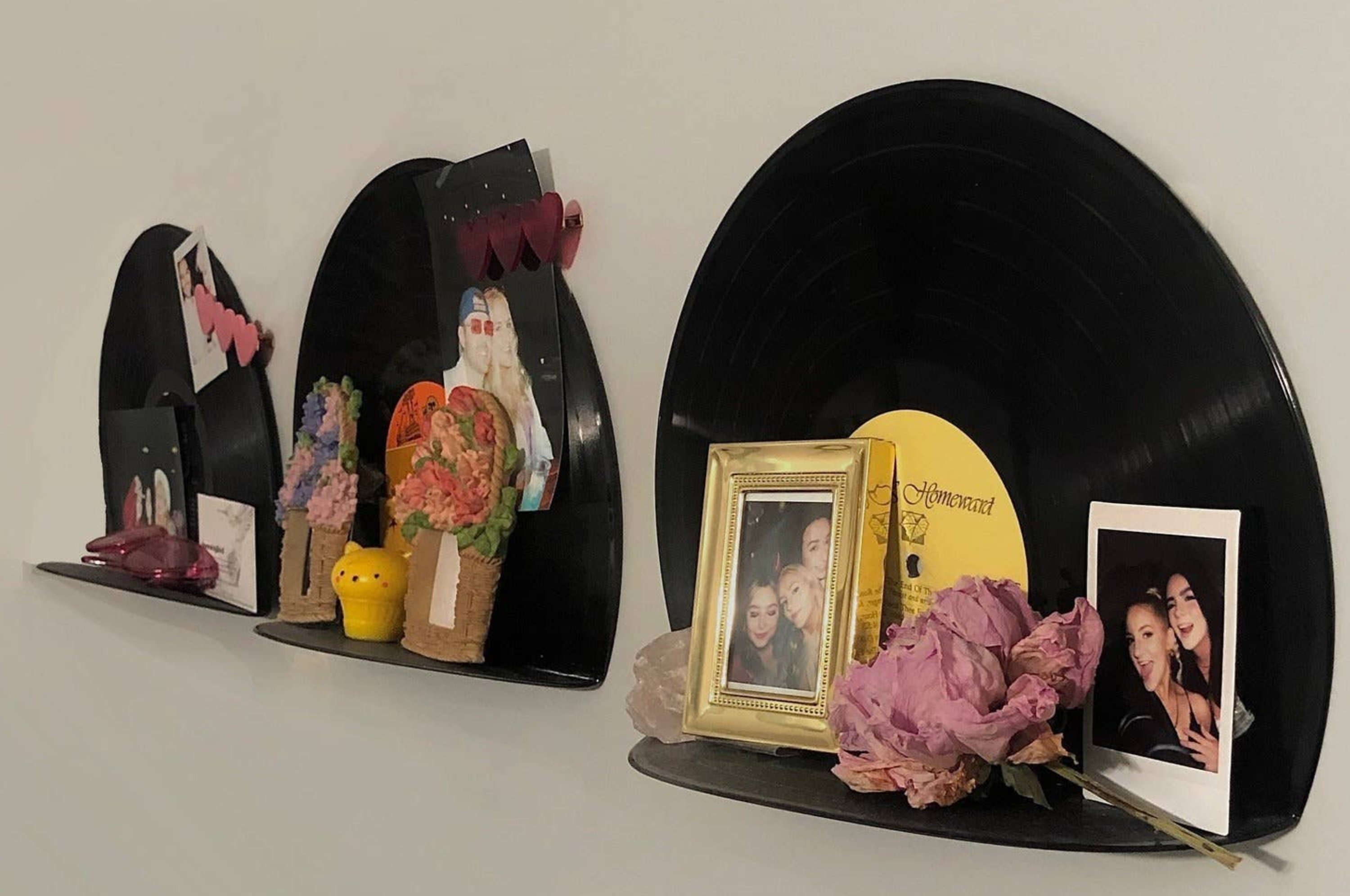 Left: Decorative shelves with vinyl records, photos, and small ornaments. Right: A variety of clothes hung on plastic hangers in a closet