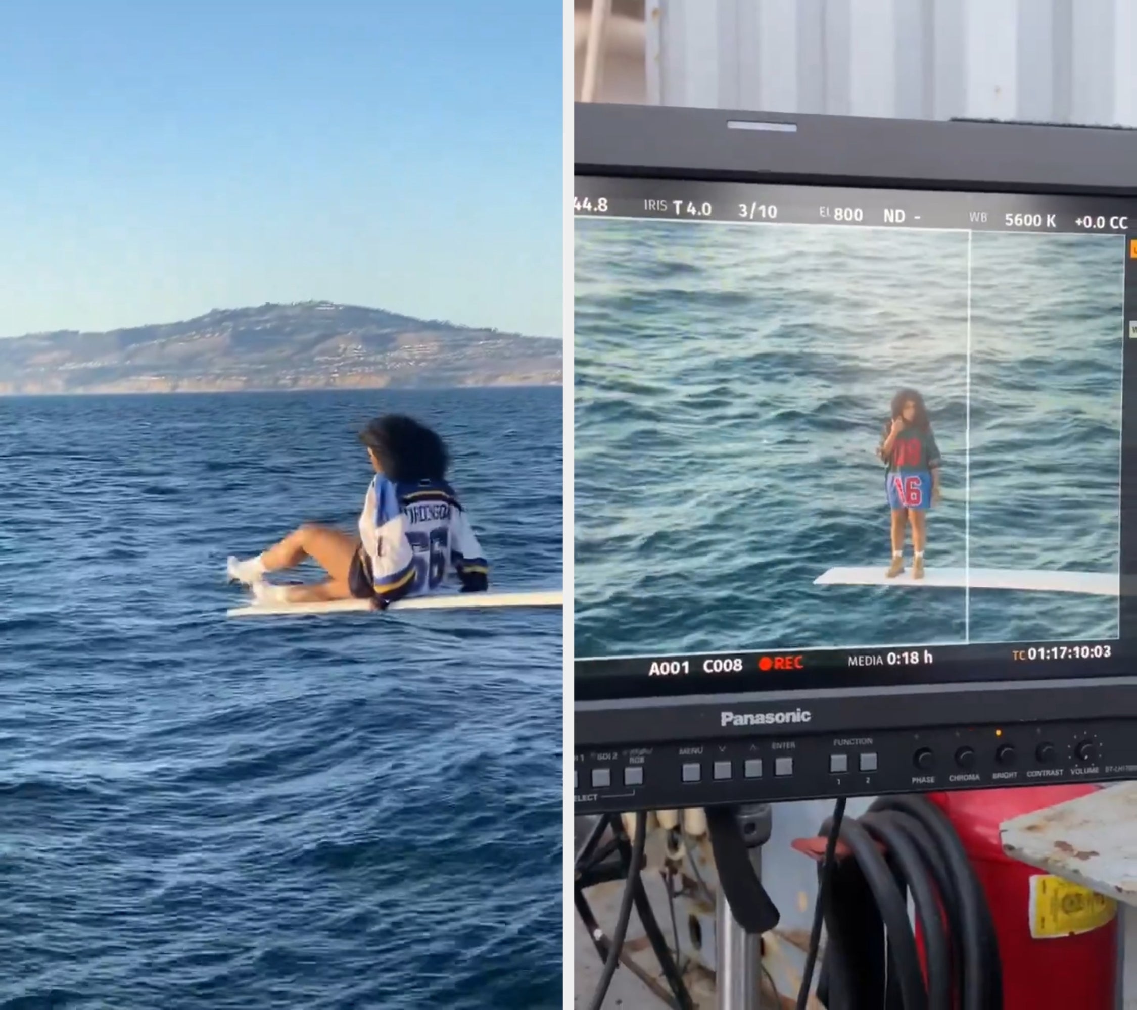 Person sitting connected  a surfboard successful  calm water  waters, wearing a jersey with "66" connected  the back, with distant   hills disposable   successful  the background