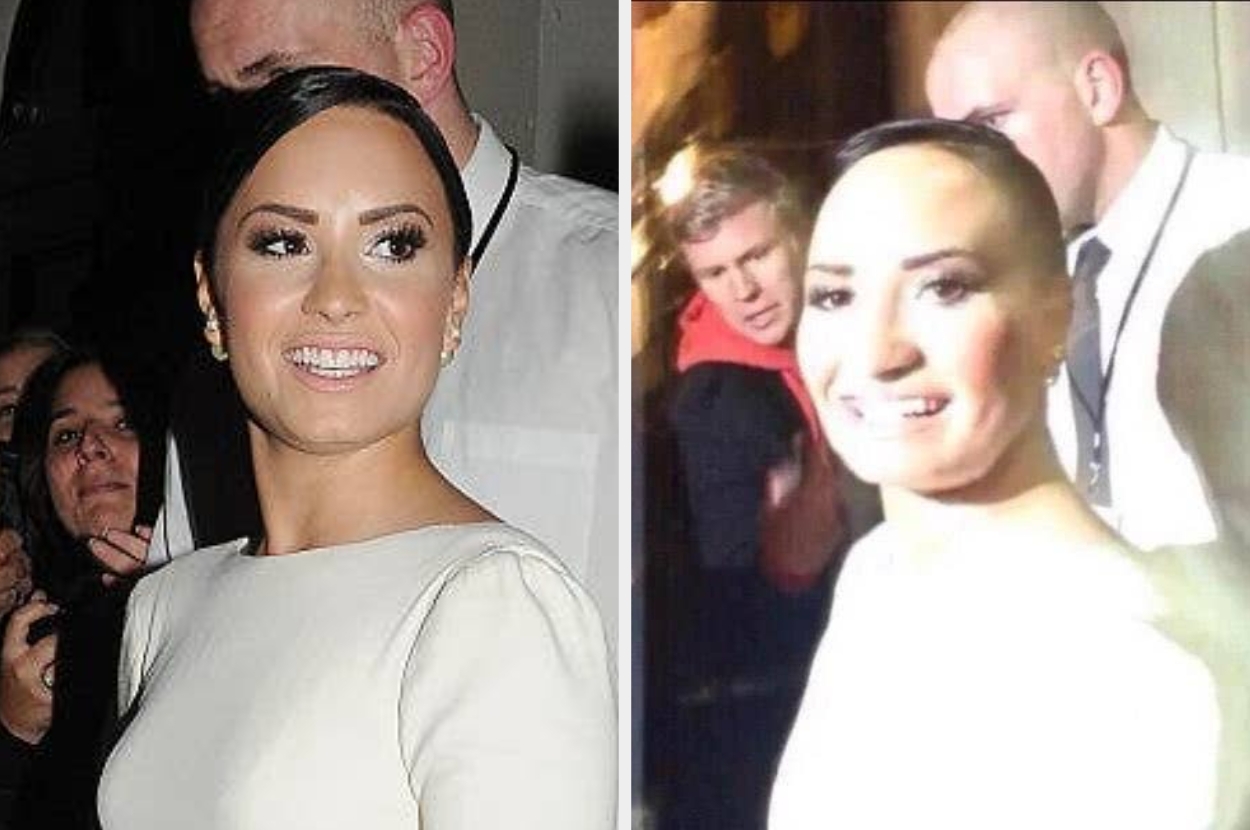 Person in elegant attire smiling at an event with fans and security nearby