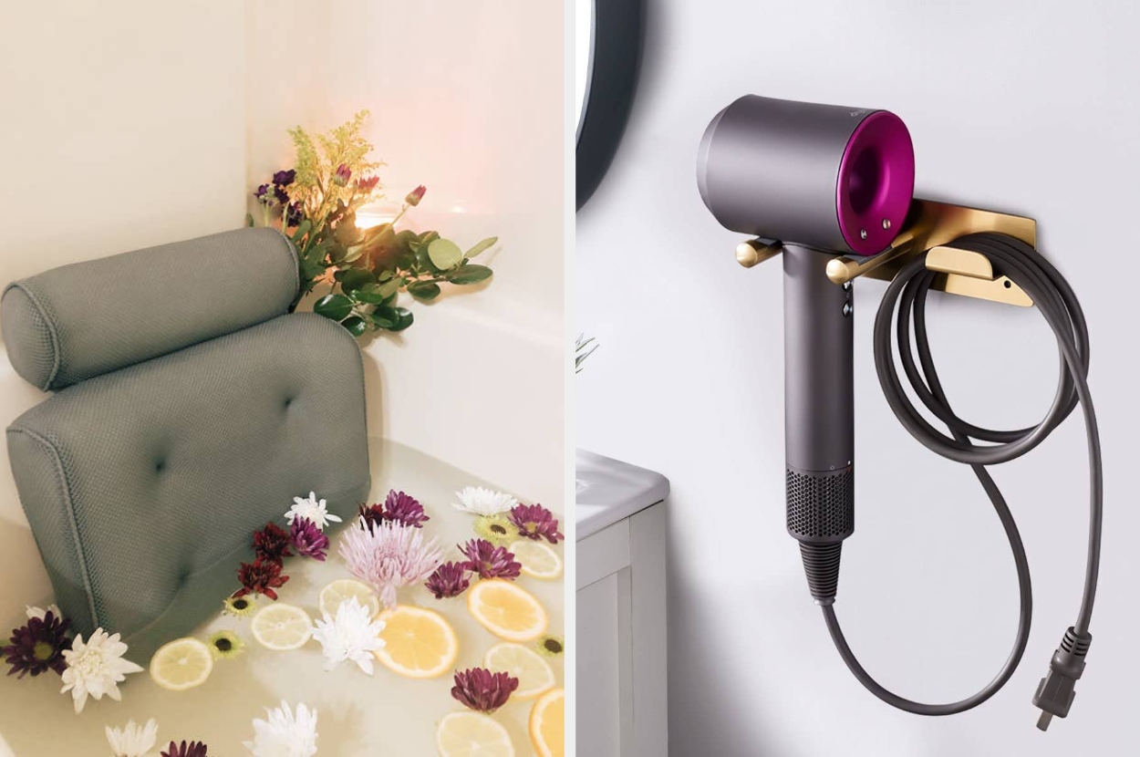 Bathtub with floral and citrus decor next to a wall-mounted hairdryer, illustrating a luxury bathroom setup