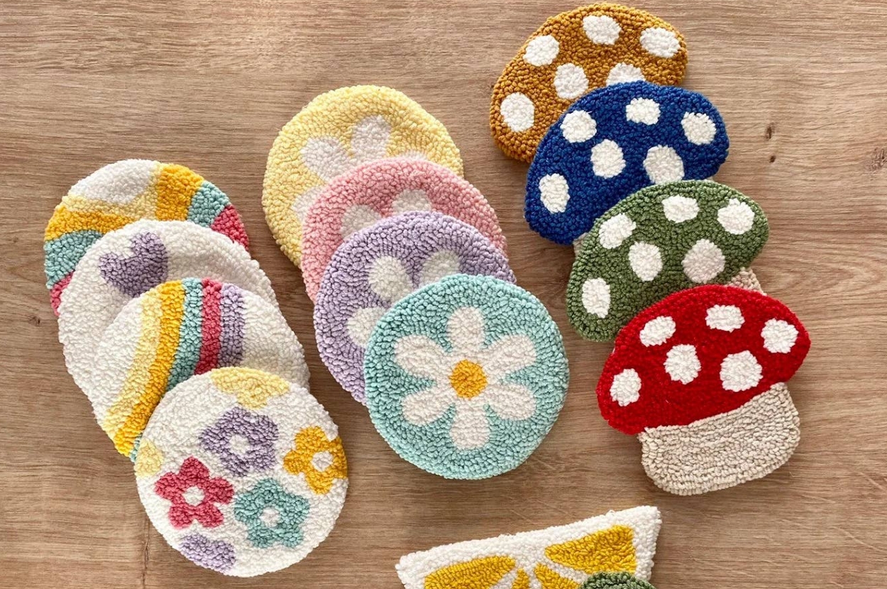Textured, round and mushroom-shaped rugs with floral and polka dot patterns on a wooden surface, ideal for decorative and home shopping interests