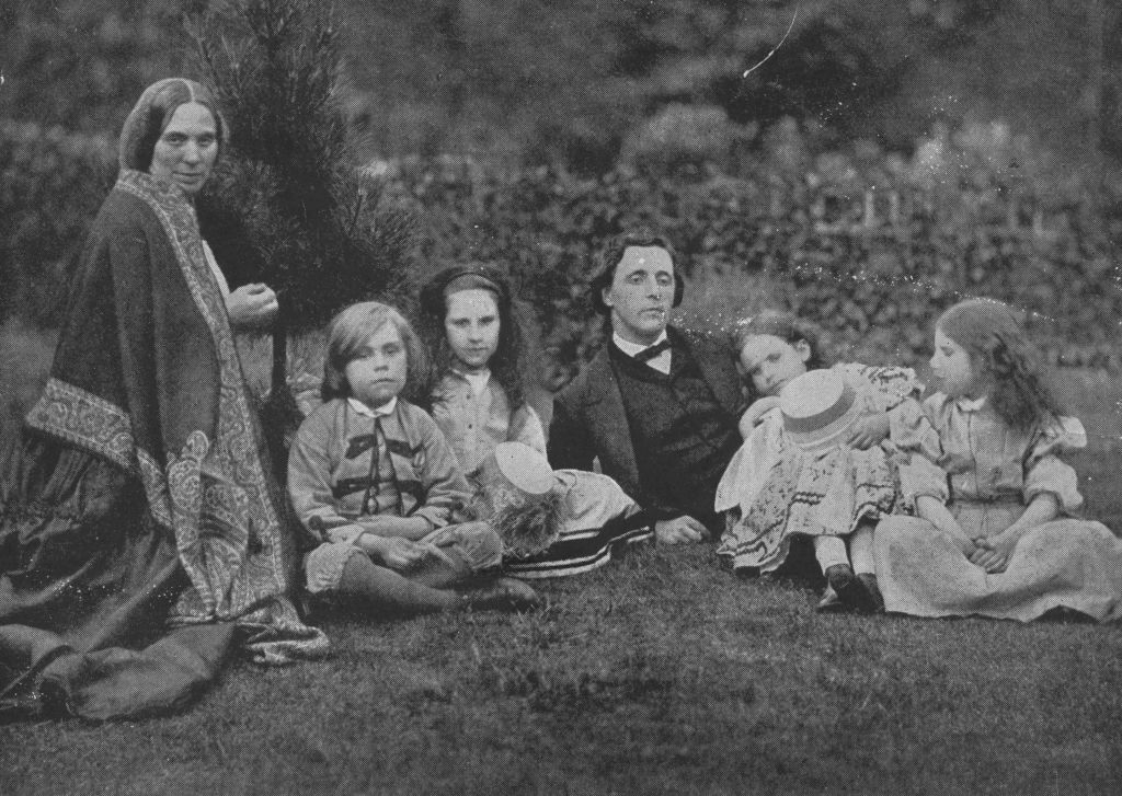 A relaxed 19th-century household  representation    of adults and children sitting and lounging connected  writer  successful  a garden
