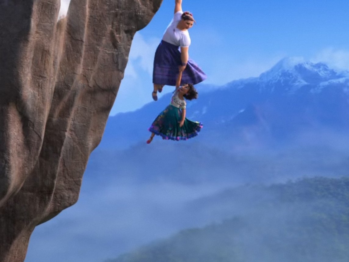 Two animated characters hang off a snowy cliff edge, with a mountainous landscape in the background