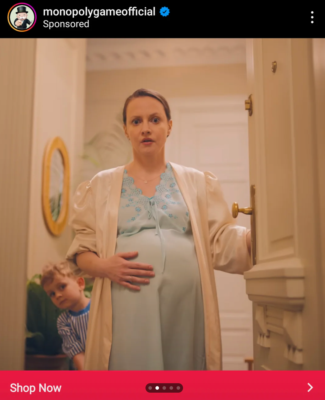 Person in a robe stands in a doorway, holding their pregnant belly, with a child peeking around the door frame