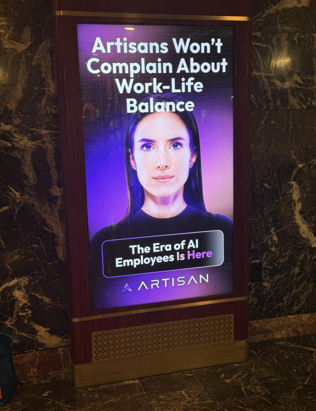Digital ad showing a serious-looking person with text: "Artisans Won't Complain About Work-Life Balance. The Era of AI Employees Is Here."