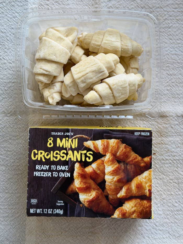 Open box of Trader Joe's 8 Mini Croissants with frozen, unbaked croissants inside a clear plastic tray