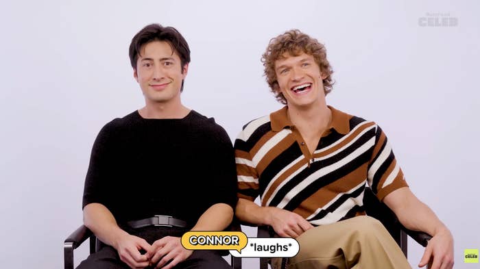 Two smiling individuals sit side by side; one wears a black shirt, the other a striped shirt, with a caption that reads "CONNOR *laughs*"
