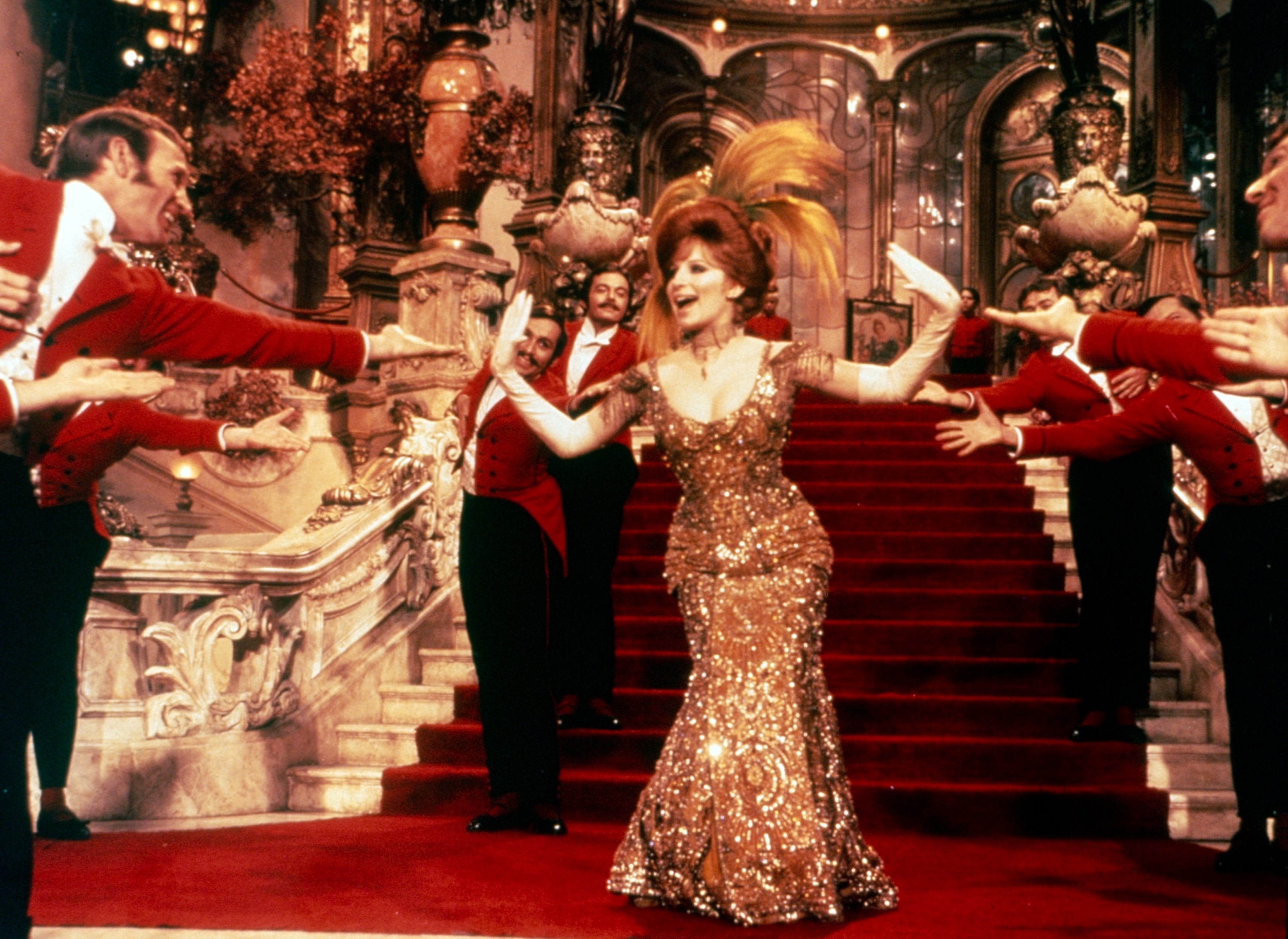 Barbara Streisand successful  an elegant sequined gown surrounded by men successful  reddish  uniforms
