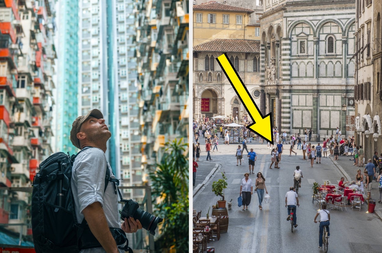 Man with camera backpack looks up at tall buildings; people walk and cycle in scenic city square