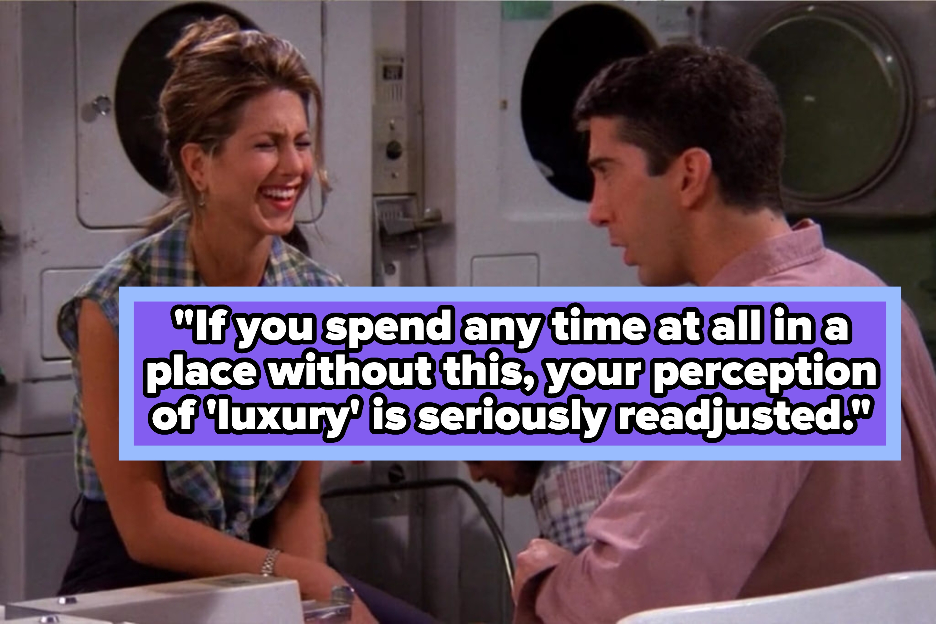 Two people laughing and talking in a laundromat, with a friend in the background. One wears a plaid shirt, and the other wears a casual top