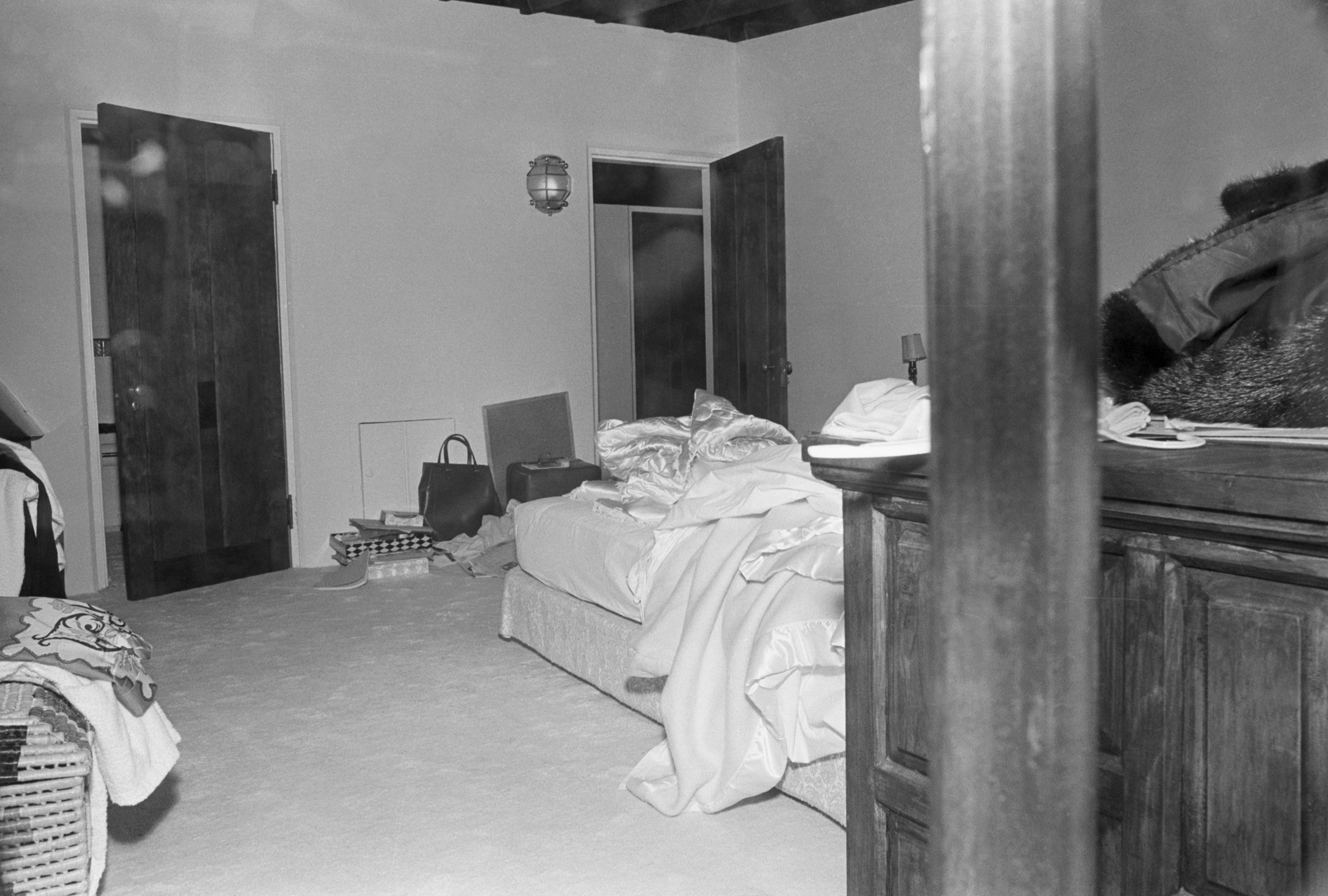 Disheveled chamber  with unmade bed, unfastened  closet, and scattered belongings, conveying a consciousness   of upset  oregon  caller    hurried departure