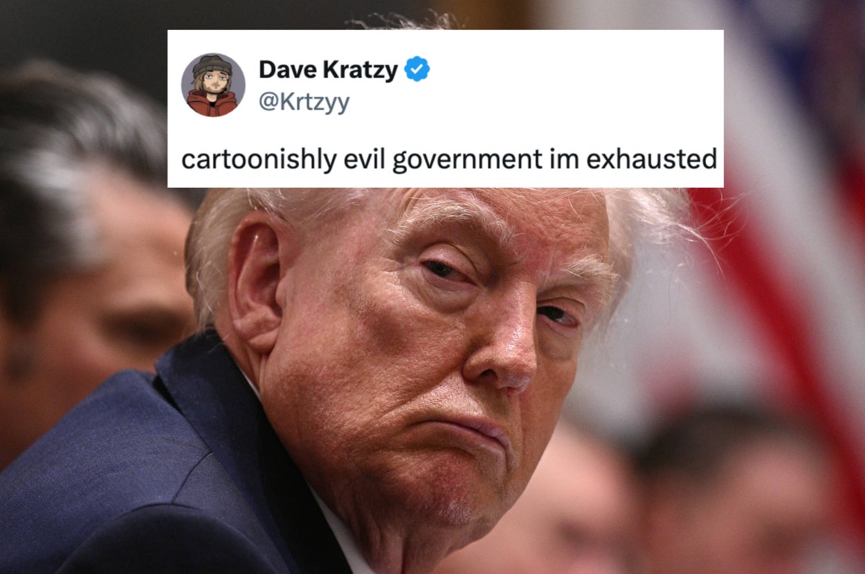 Person in suit smiling and pointing playfully, set against a blue background