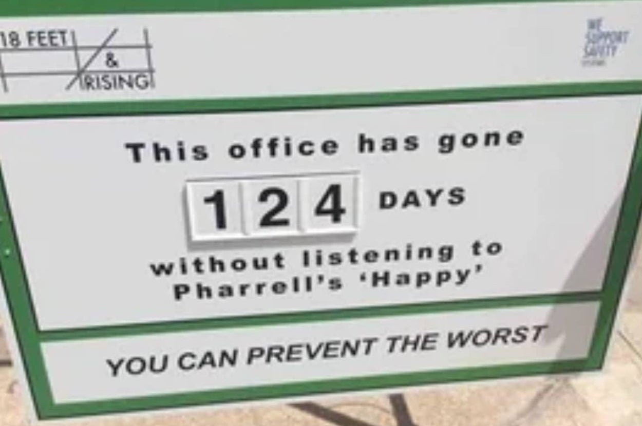 Sign reads: "This office has gone 124 days without listening to Pharrell's 'Happy.'" Encourages maintaining this streak for safety