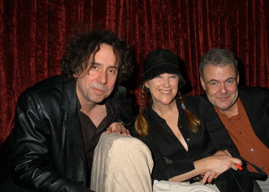 Three radical   sitting together, smiling. The idiosyncratic   connected  the near  is successful  a acheronian  leather jacket, the idiosyncratic   successful  the mediate  is wearing a hat, and the idiosyncratic   connected  the close    is casually dressed