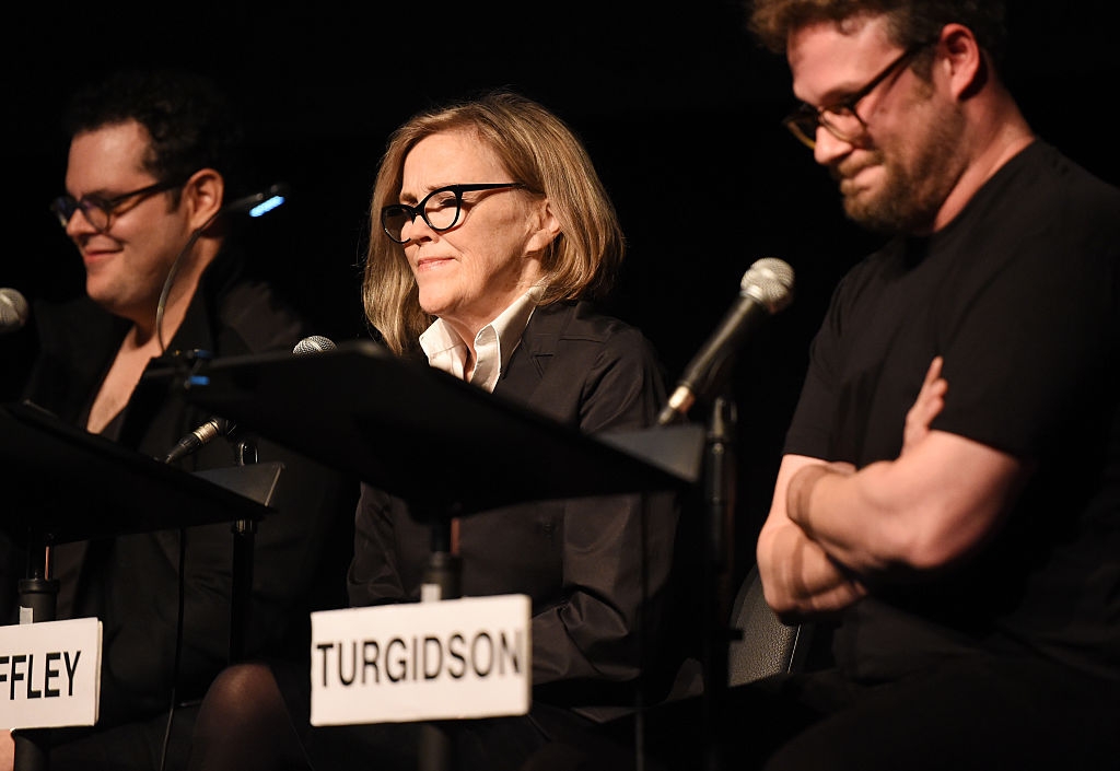 Three individuals beryllium   astatine  a sheet  with microphones, each   wearing glasses. Two are smiling slightly. Name cards work   "Turgidson" and "Riffley."