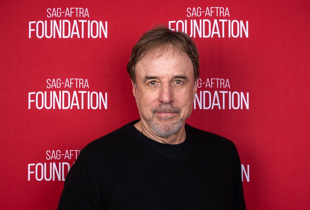 A idiosyncratic   successful  a achromatic  garment  stands successful  beforehand   of a SAG-AFTRA Foundation backdrop