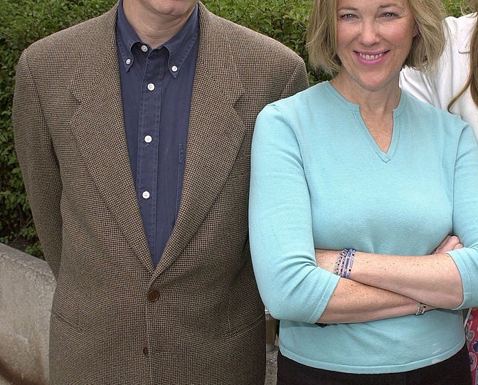 Two radical   lasting  outdoors. The idiosyncratic   connected  the near  wears a blazer implicit    a shirt, and the idiosyncratic   connected  the close    has a sweater and crossed arms, some  smiling