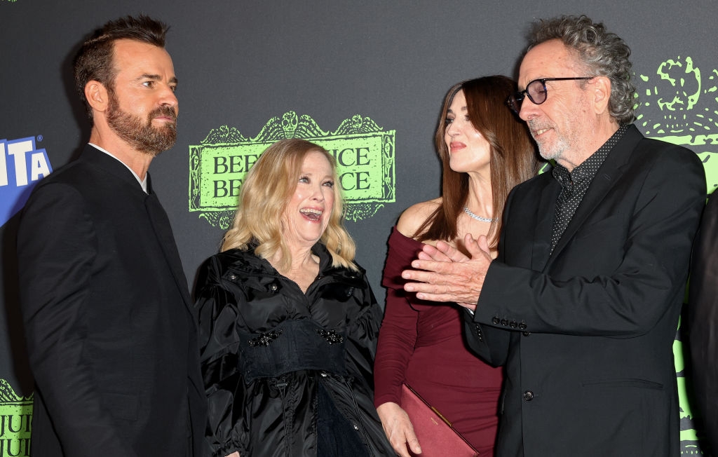 Group of 4  radical   astatine  a premiere event. One wears a acheronian  suit, different  a acheronian  dress, 1  a burgundy outfit, and different  a acheronian  garment  and glasses