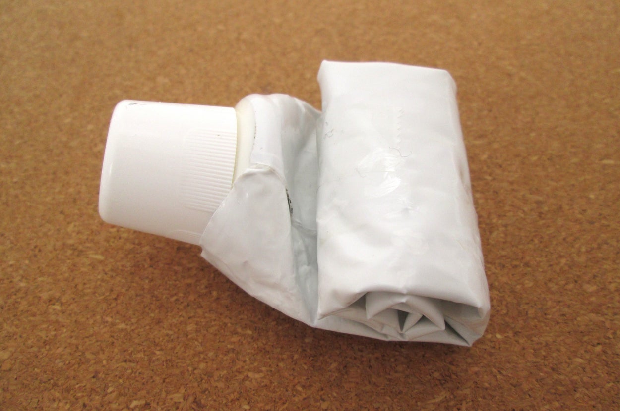 歯磨き粉のチューブが最後まで使われ、丸められて押し出された状態。