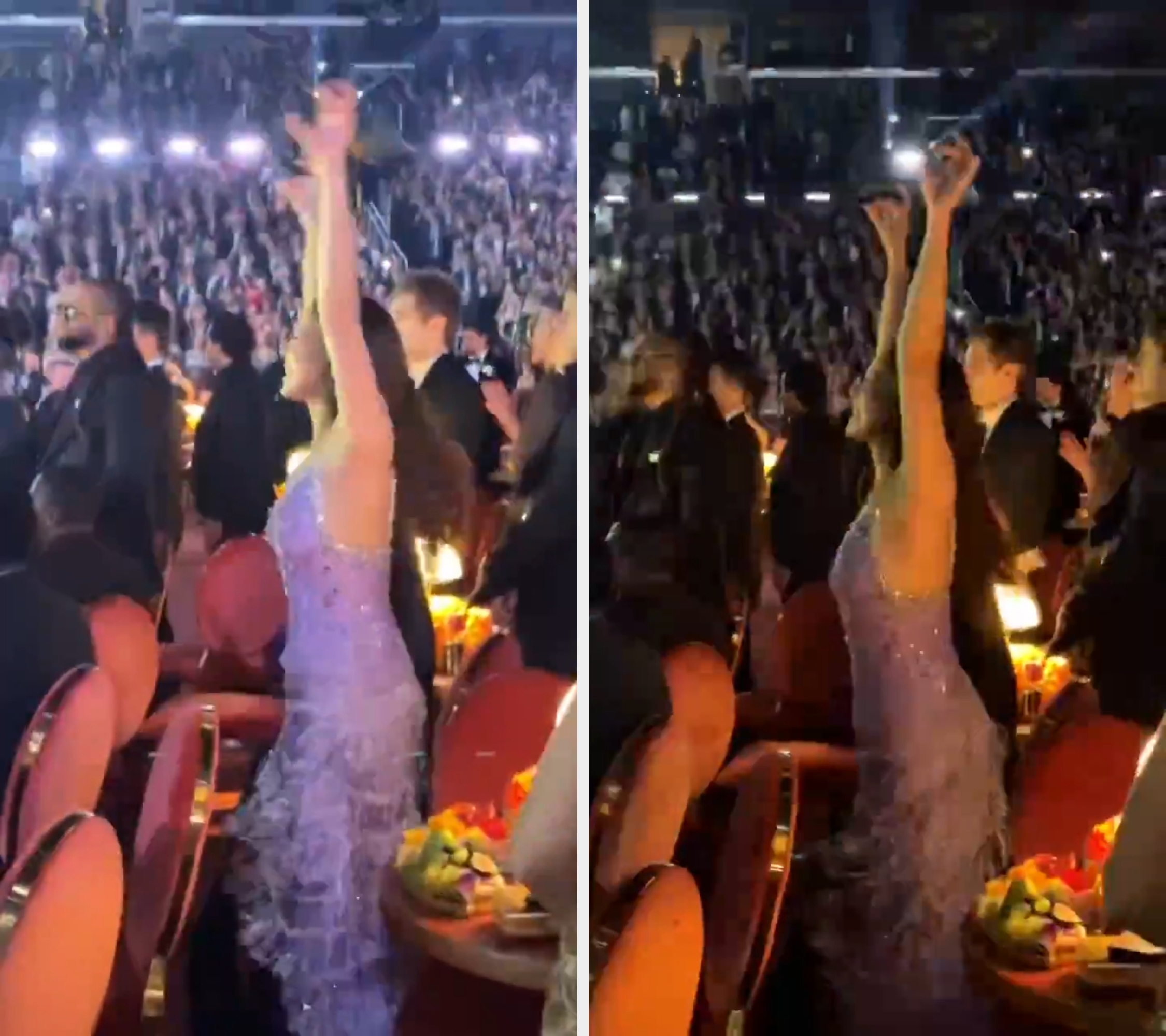 Audience subordinate   joyfully raises hands among cheering assemblage  astatine  an indoor event. Person wears a detailed, sparkly gown
