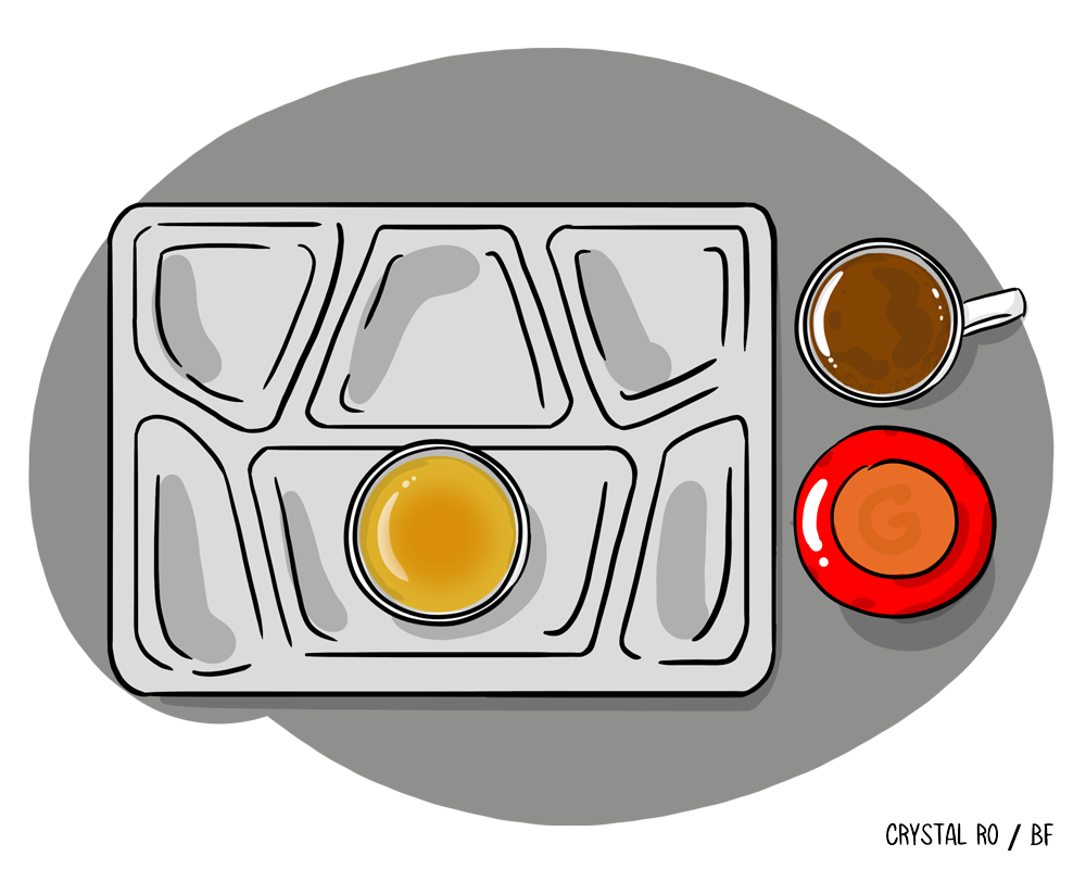 Empty school lunch tray with a bowl of soup, coffee, and a small red plate on a gray surface