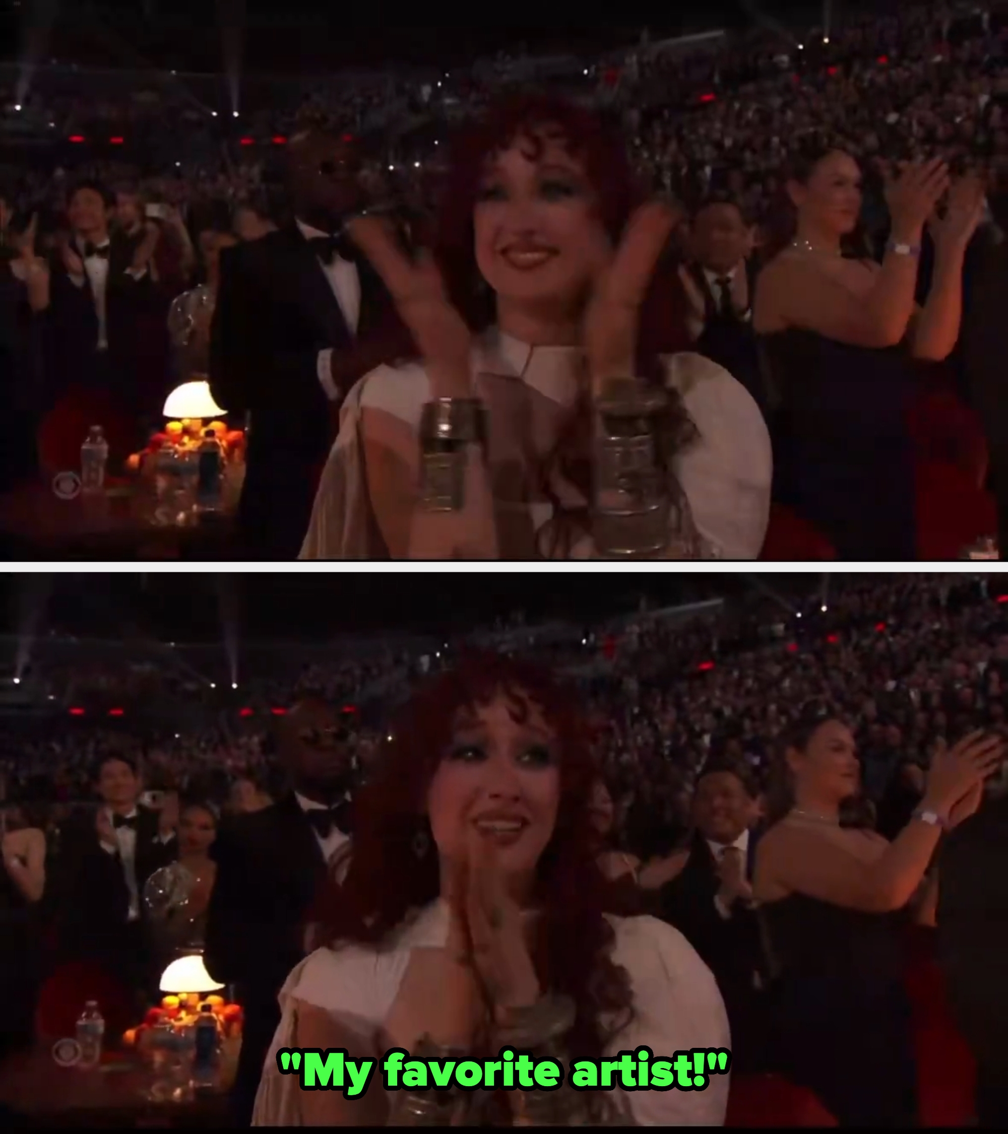 A idiosyncratic   successful  a glamorous outfit claps enthusiastically successful  a crowded event, perchance  an grant  amusement   audience