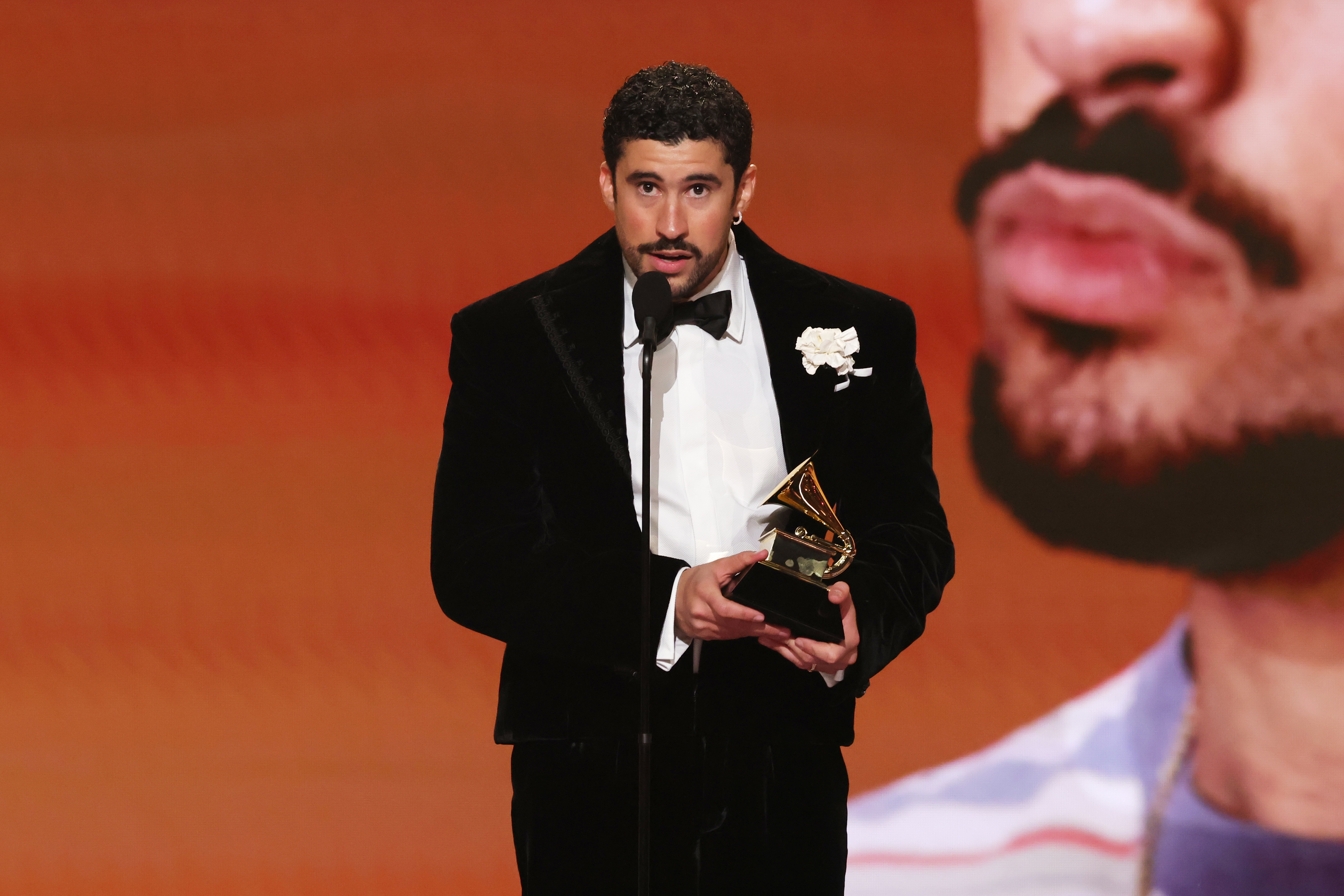 A idiosyncratic   successful  a tuxedo holds a Grammy grant  connected  stage