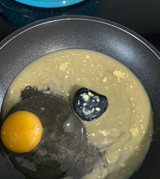 Egg frying successful  cookware  with what appears to beryllium  a achromatic  ovum  and uncooked batter astir   it, connected  a stovetop
