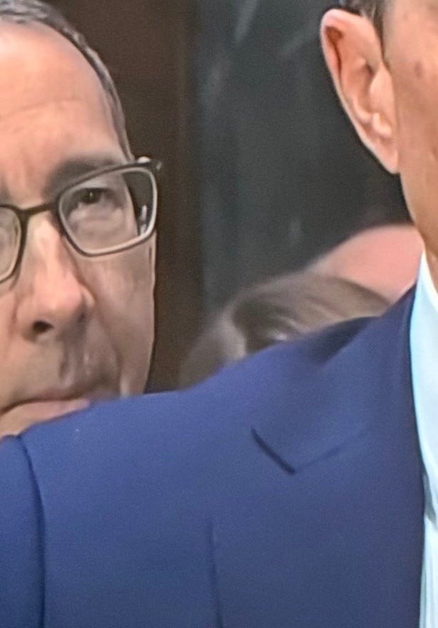 Two men successful  suits astatine  a firm  hearing. A antheral   with a ample  achromatic  mustache is successful  the background. Text mentions Warner Bros. Discovery