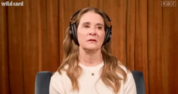 A idiosyncratic   with agelong  hairsbreadth  wears headphones successful  a signaling  workplace  setting, featured successful  an audio oregon  podcast interview