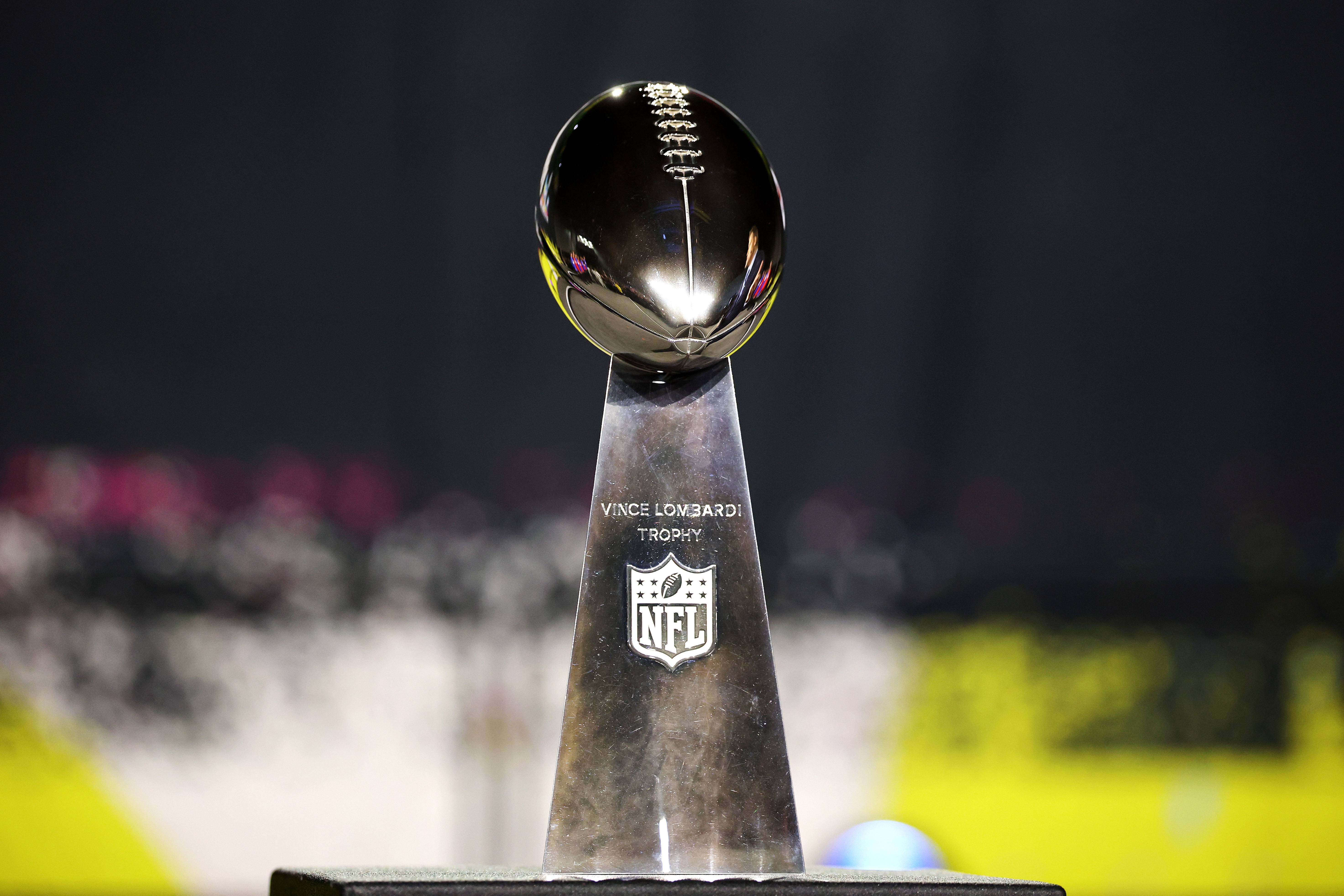 The Vince Lombardi Trophy, awarded to the Super Bowl champion, is displayed connected  a pedestal