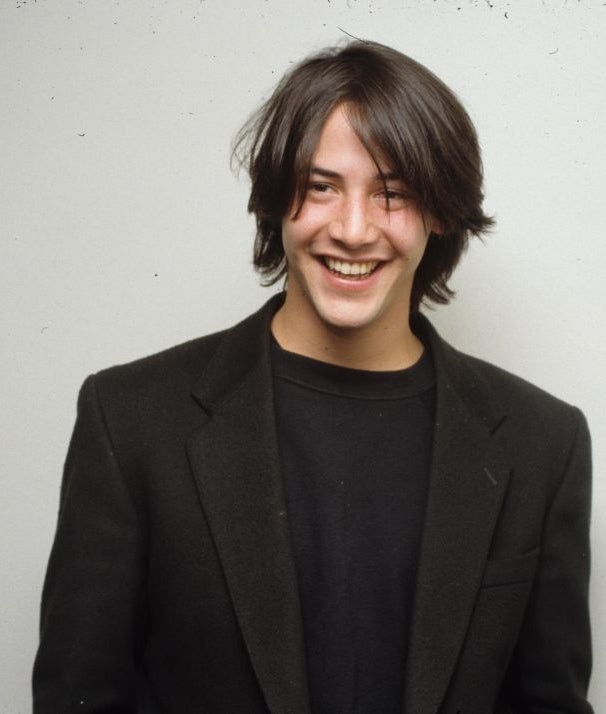 A idiosyncratic   with shoulder-length hairsbreadth  smiles warmly portion    wearing a elemental  achromatic  blazer implicit    a acheronian  shirt